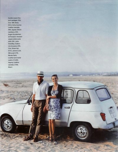 A pair of models pose in front of a white Renault 4, against a desert coastline backdrop