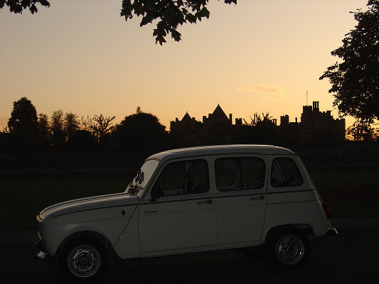Dusk falls as the car is still waiting in the grounds of the mansion